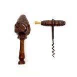 An early French turned mahogany corkscrew with brush, together with a black forest screw turn