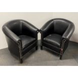 A pair of black leather upholstered tub chairs.