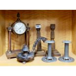 A pair of Art Nouveau pewter candle sticks with a pair of wooden candle sticks, a wooden