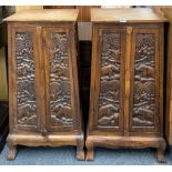 A pair of carved Indian wooden cabinets, W. 56cm, H. 102cm.