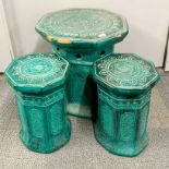 An Eastern glazed pottery garden table, 53 x 53 x 53cm, with two matching stools.