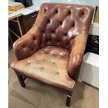 A gentleman's button backed leather upholstered armchair.