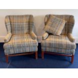 A pair of impressive re-upholstered wingback armchairs.