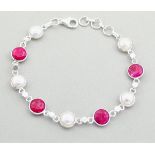 A 925 silver bracelet set with baroque pearls and rubies, L. 19cm.