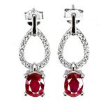 A pair of 925 silver drop earrings set with an oval cut ruby and white stones, L. 2.2cm.