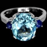 A 925 silver ring set with a large oval cut Swiss blue topaz and sapphire set shoulders, (N).