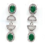 A pair of 925 silver drop earrings set with oval cut emeralds and white stones, L. 3cm. Condition