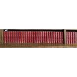 Thirty three red tooled leatherbound volumes of 'The universal anthology of the best literature'