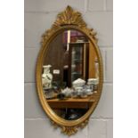 An oval gilt framed mirror, 46 x 83cm.
