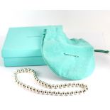 A boxed Tiffany & Co 925 silver ball necklace, with gift pouch.