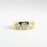 A gentleman's 18ct yellow and white gold ring set with three brilliant cut diamonds, approx. 1.03ct,