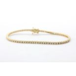 A yellow metal (tested 14ct gold) tennis bracelet set with brilliant cut diamonds, approx. 2.56ct,