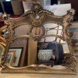 A gilt over mantle mirror, W. 140cm. H. 122cm.