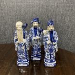 A set of three Chinese hand painted porcelain figures of lucky gods, H. 30cm.