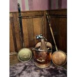 An antique copper coal skuttle with two warming pans and a copper jug.