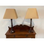 A pair of attractive turned wood table lamps and shades, H. 72cm.