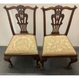 A pair of handsome ball and claw foot carved mahogany hall chairs with tapestry seats (A/F).