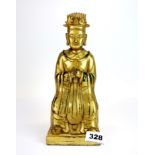 A Tibetan gilt bronze figure of a seated deity, H. 24cm.