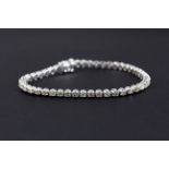 A 14ct white gold (stamped 14k) tennis bracelet set with brilliant cut diamonds, approx. 4.08ct,