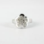 A 14ct white gold (stamped 585) diamond set flower cluster ring, (K).