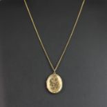 A 9ct yellow gold (stamped 375) portrait pendant and chain, L. 4cm.