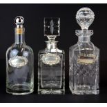 Two cut glass decanters (one with hallmarked silver collar) with a further decanter, two