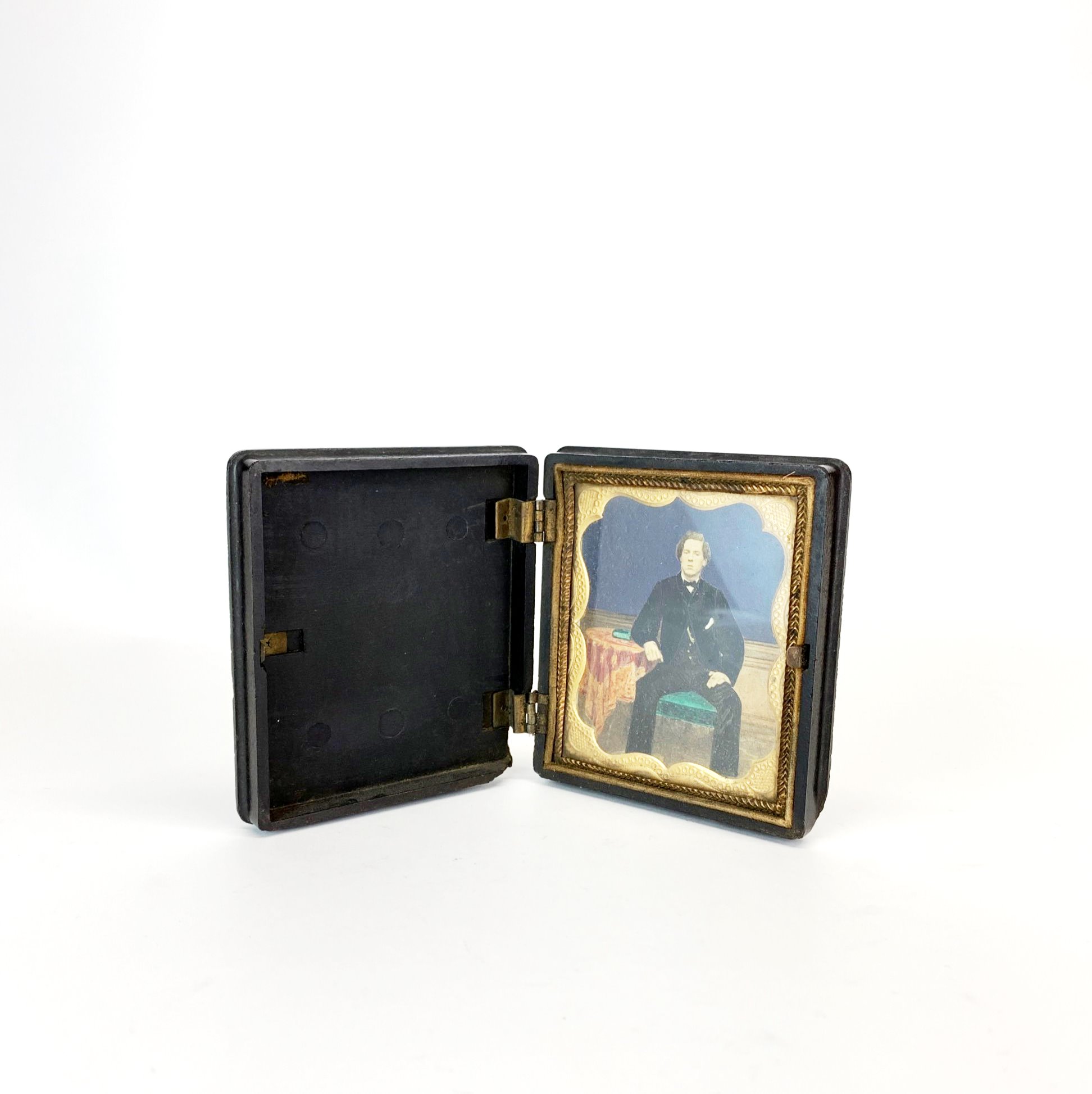 A 19th century vulcanite cased handpainted photograph portrait of a young man (A/F), 8.5 x 9.5 x