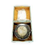 A cased compass, 23 x 23 x 15cm.