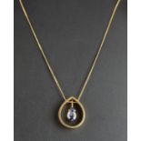 A yellow metal (tested minimum 9ct gold) pendant and chain, set with a pear cut synthetic