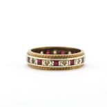 A yellow and white metal (tested gold and silver) ring set with rubies and white stones, (M).