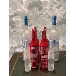 A group of large vodka advertising bottles, largest 57cm.