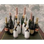 A collection of sealed champagne advertising display alcohol bottles, largest 50cm.