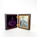 A mid-Victorian vulcanite framed tinted glass daguerreo type photograph of a young man, 8.5 x 9.5