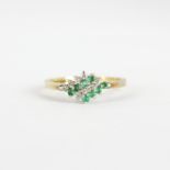 A 9ct yellow gold emerald and diamond set cluster ring, (N.5).