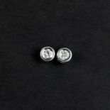 A pair of 18ct white gold (stamped 18k) rub over brilliant cut diamond set stud earrings, overall