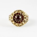 A 9ct yellow gold garnet set cluster ring, (M.5).