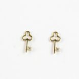 A pair of 14ct yellow gold (stamped 14k) diamond set key shaped stud earrings, L. 0.9cm.