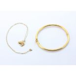 A 14ct yellow gold (stamped 14k) bangle, together with a yellow metal (tested 9ct) horse pendant and