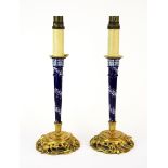 A pair of Omalu mounted porcelain candlestick style table lamps (currently not wired for use), H.