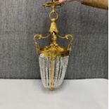A gilt metal and cut glass chandelier light fitting, H. 70cm.