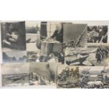 A collection of mostly WWII large press photographs of various military subjects, mostly enlarged to