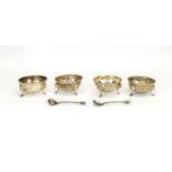 A cased set of four hallmarked silver mustard bowls, London c. 1878, with two matching spoons.