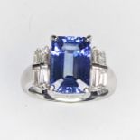 A hand made Platinum emerald cut estimated AAA Tanzanite with baggette cut Diamond sholders.