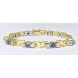 A 14ct yellow gold pre loved sapphire and diamond claw set stones with yellow gold cut out sections.