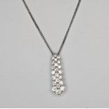 A 18ct white gold diamond drop multi row claw set pendant containing Approx. 0.70 cts of fine
