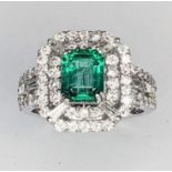 An 18ct white gold Emerald and Diamond cluster Art Deco style ring. The ring consists of baggette