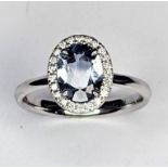 A 18ct white gold rare oval Umba Sapphire with diamond set halo ring. Approx 1.40cts rare grey