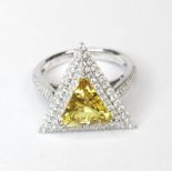 A 18ct white gold stunning trillian cut natural yellow Sapphire with diamond set halo and