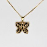 A 18ct yellow gold butterfly revarable pendant with rubys and sapphires set on diffrent sides in a