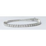 A 9ct white gold illiusion set round diamond tennis bracelet with a figure of 8 clasp section.